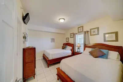 a bedroom with two beds and a tv in it at Ocean Villa 1104 in Panama City Beach