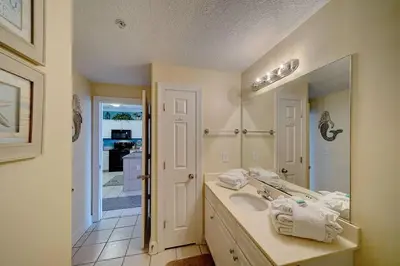 a bathroom with a sink and a mirror at Ocean Villa 1104 in Panama City Beach