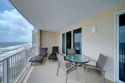 a balcony with a table and chairs and the ocean at Ocean Villa 1104 in Panama City Beach
