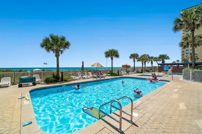 a swimming pool at a resort with people in it at Ocean Villa 1104 in Panama City Beach