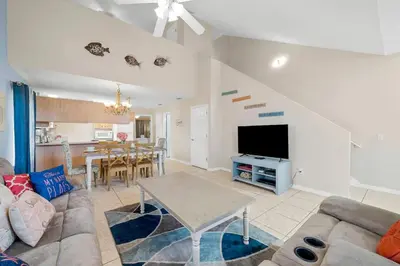 a living room with a couch and a table at 126 Seagrass Way in Panama City Beach