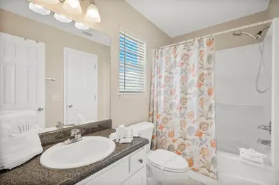 a bathroom with a sink and a toilet and a shower at 126 Seagrass Way in Panama City Beach