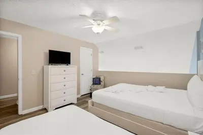 a bedroom with two beds and a ceiling fan at 126 Seagrass Way in Panama City Beach