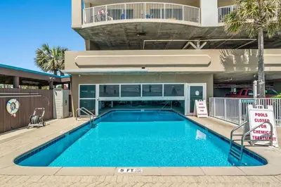 a swimming pool in front of a building at Ocean Villa 2101 in Panama City Beach