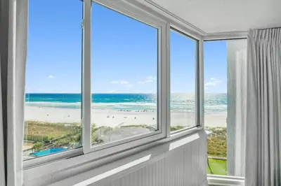 a room with a window with a view of the beach at Top Of The Gulf 613 in Panama City Beach