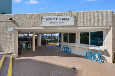 a top of the cure snack shack with blue stools at Top Of The Gulf 613 in Panama City Beach
