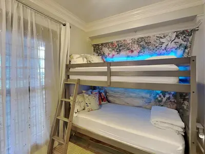 two bunk beds in a room with a window at Majestic Beach Towers I #1503 in Panama City Beach