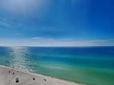 an aerial view of the ocean with chairs on the beach at Majestic Beach Towers I #1503 in Panama City Beach