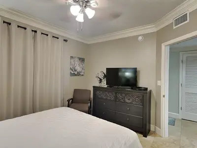 a bedroom with a bed and a television on a dresser at Majestic Beach Towers I #1503 in Panama City Beach
