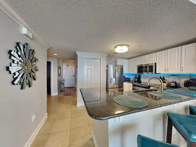 a kitchen with white cabinets and a counter top at Majestic Beach Towers I #1503 in Panama City Beach