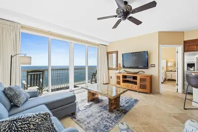 a living room with a couch and a tv at Emerald Coast Escapes in Panama City Beach