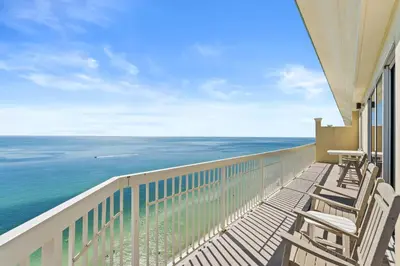a balcony with chairs and a view of the ocean at Emerald Coast Escapes in Panama City Beach