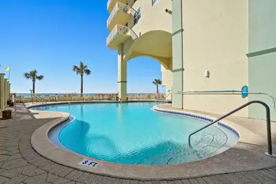 a swimming pool in front of a building at Emerald Coast Escapes in Panama City Beach