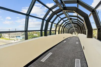 a walkway in a building with a glass ceiling at Emerald Coast Escapes in Panama City Beach
