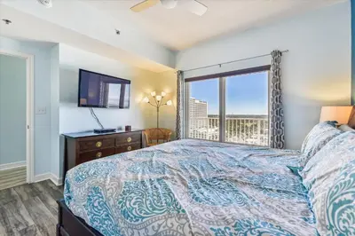 a bedroom with a bed and a window with a view at Shores of Panama 1427 condo in Panama City Beach