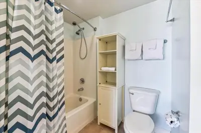 a bathroom with a toilet and a shower at Shores of Panama 1427 condo in Panama City Beach