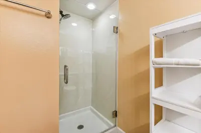 a shower with a glass door in a bathroom at Shores of Panama 1427 condo in Panama City Beach