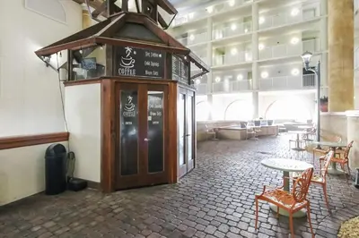 a building with a table and chairs in a room at Shores of Panama 1427 condo in Panama City Beach