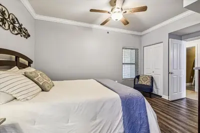 a bedroom with a bed and a ceiling fan at Shores of Panama 723 condo in Panama City Beach