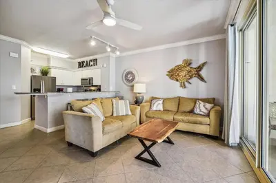 a living room with two couches and a table at Shores of Panama 723 condo in Panama City Beach