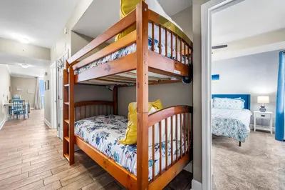 a childs bedroom with a bunk bed and a staircase at Beautiful Beach front condo! - Tidewater 1804 in Panama City Beach