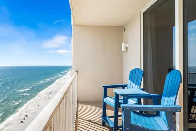 two blue chairs on a balcony looking out at the ocean at Beautiful Beach front condo! - Tidewater 1804 in Panama City Beach