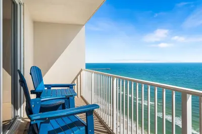 two blue chairs on a balcony looking out at the ocean at Beautiful Beach front condo! - Tidewater 1804 in Panama City Beach