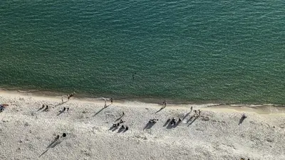 a group of people standing on the beach at Beautiful Beach front condo! - Tidewater 1804 in Panama City Beach