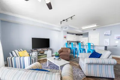 a living room with two couches and a tv at Beautiful Beach front condo! - Tidewater 1804 in Panama City Beach