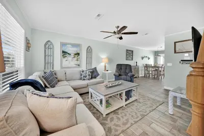 a living room with a couch and a table at All Decked Out on PCB in Panama City Beach