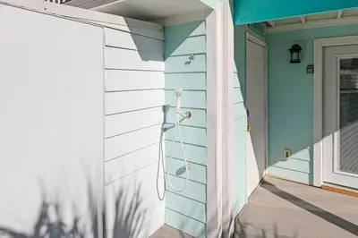 a home with a blue wall and a door at All Decked Out on PCB in Panama City Beach