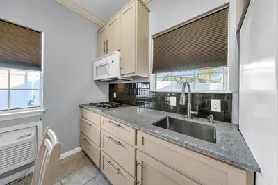 a kitchen with a sink and a microwave at The Palms A6 in Panama City Beach