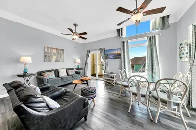 a living room with a couch and chairs and a table at The Palms A6 in Panama City Beach