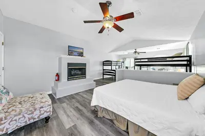 a bedroom with a bed and a ceiling fan at The Palms A6 in Panama City Beach