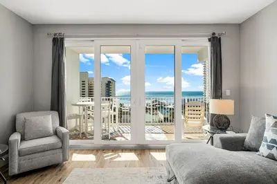 a living room with a view of the ocean at Laketown Wharf #626 by Nautical Properties in Panama City Beach