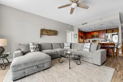 a living room with a couch and a ceiling fan at Laketown Wharf #626 by Nautical Properties in Panama City Beach