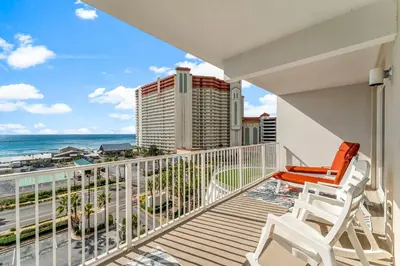 a balcony with chairs and a view of the ocean at Laketown Wharf #626 by Nautical Properties in Panama City Beach