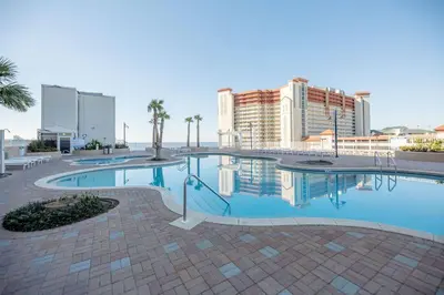 a large swimming pool with buildings in the background at Laketown Wharf #626 by Nautical Properties in Panama City Beach