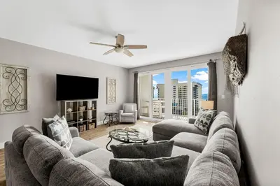 a living room with a couch and a tv at Laketown Wharf #626 by Nautical Properties in Panama City Beach