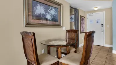 a dining room with a table and chairs at Tidewater 1312 in Panama City Beach