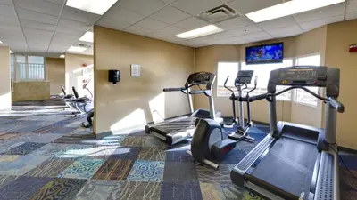 a gym with treadmills and ellipticals in a room at Tidewater 1312 in Panama City Beach