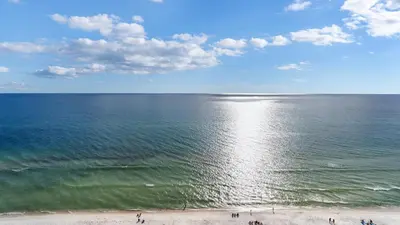 a view of the ocean with people on the beach at Tidewater 1312 in Panama City Beach