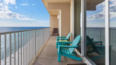 a balcony with two chairs and the ocean at Tidewater 1312 in Panama City Beach