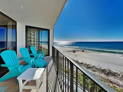 a balcony with blue chairs and a view of the beach at Edgewater Tower Iii 504 in Panama City Beach