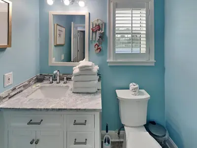 a blue bathroom with a sink and a toilet at Beachside Villas 911 in Seagrove Beach