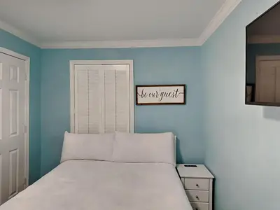 a bedroom with a bed and a sign that reads not all quiet at Beachside Villas 911 in Seagrove Beach