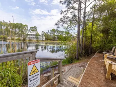 a sign on a wooden bridge near a body of water at Beachside Villas 911 in Seagrove Beach