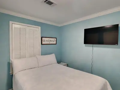 a bedroom with a bed and a flat screen tv at Beachside Villas 911 in Seagrove Beach