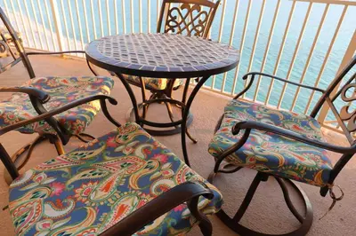 a table and chairs sitting on a balcony at AQUA 1504 Beachfront condo with Free Beach Chairs in Panama City Beach