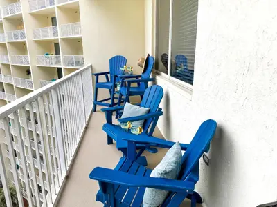 a row of blue chairs on a balcony at Shores Of Panama #0912 in Panama City Beach